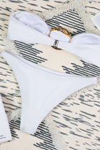 White three-piece swimsuit with ruching and high-cut leg