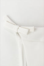 Casual sleeveless top with a tie detail at the hem and a sweet style