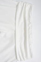 Conjunto de top corto de cuello alto y pantalones acampanados en color liso